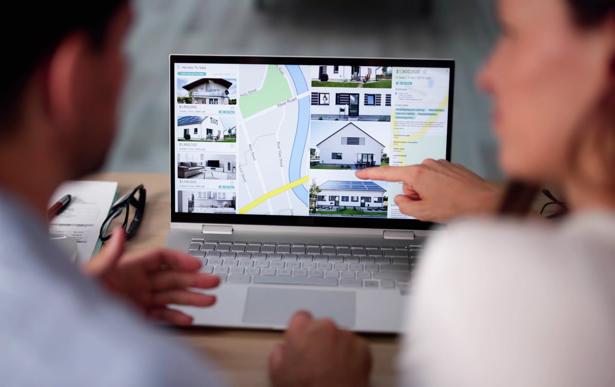 Family reviewing real estate and housing options on laptop — parent rent-vs-buy decision near Florida State University