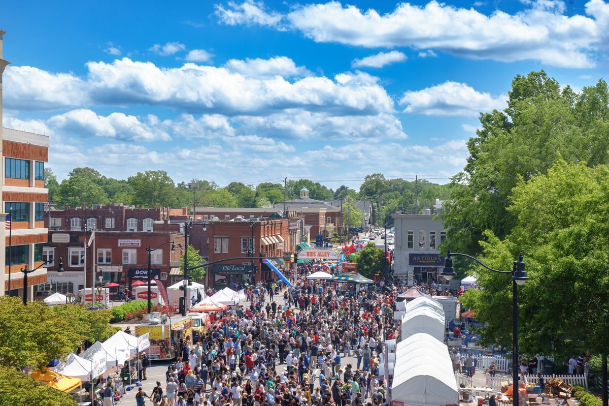 Historic downtown square with local shops and restaurant patios