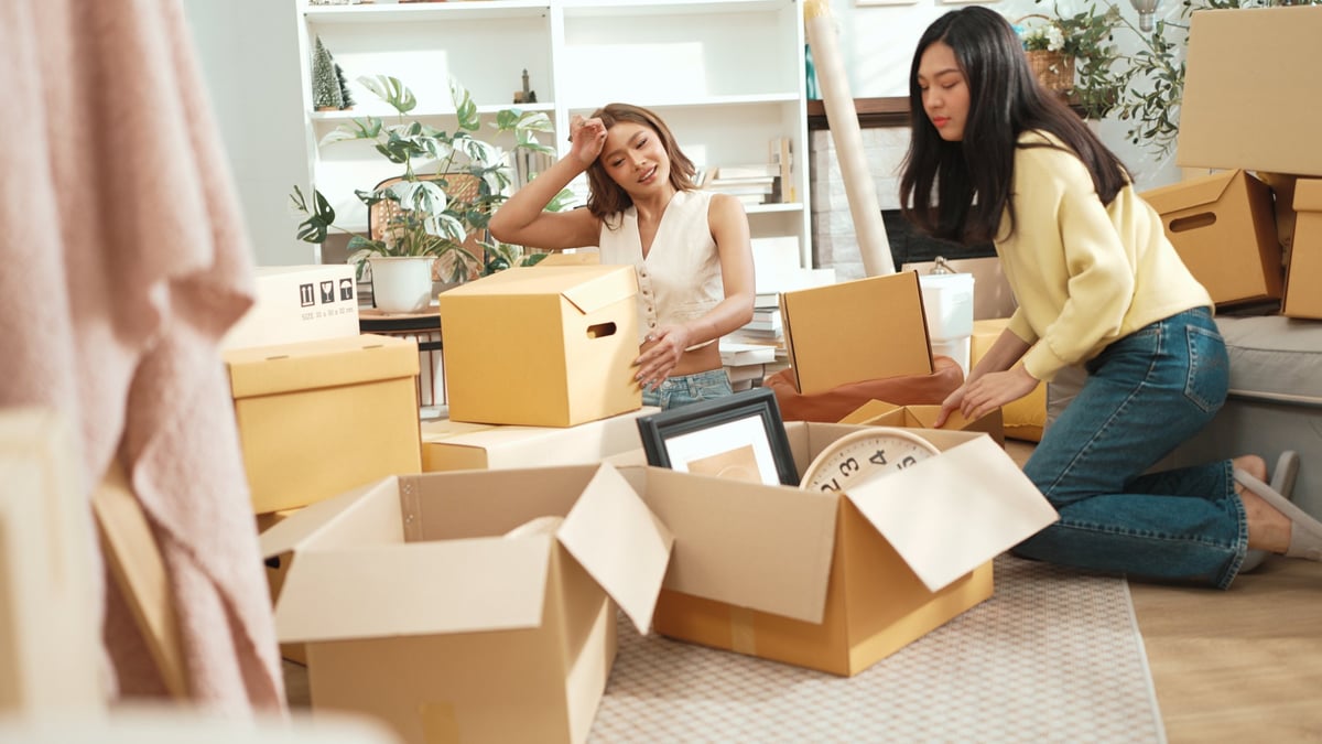 College students collaborating and studying together in a modern apartment living room near campus