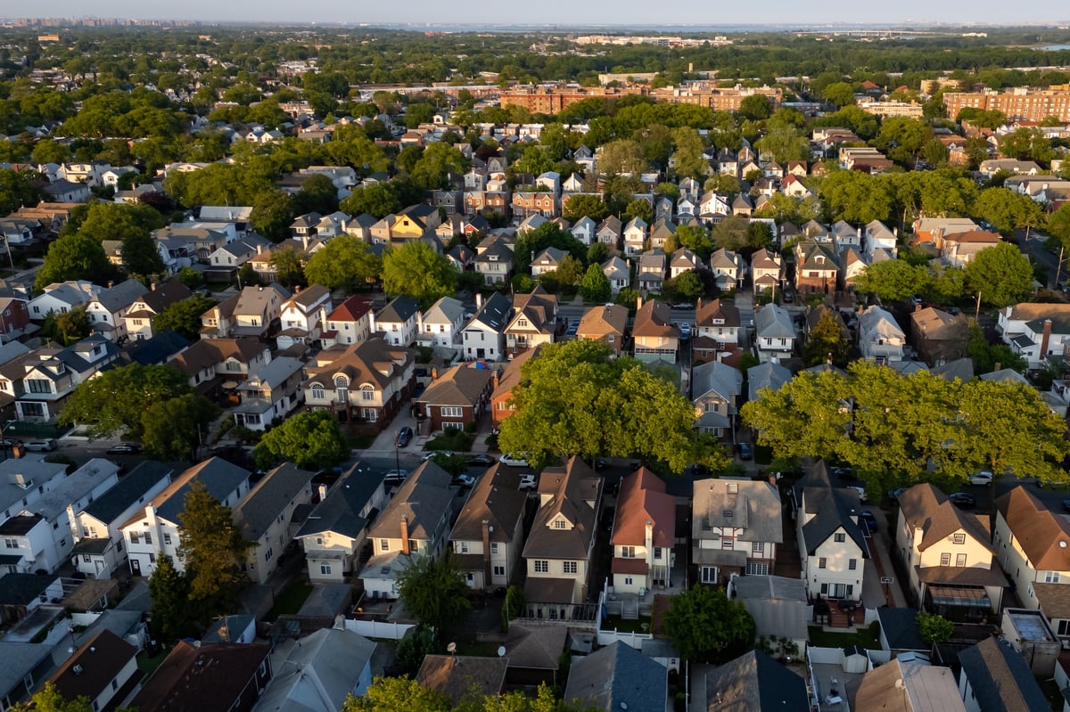 Tree-lined residential street with suburban homes