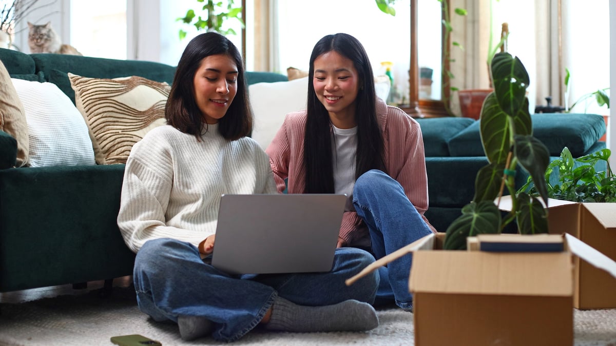 College roommates studying with laptops in shared off-campus living space near Florida State University