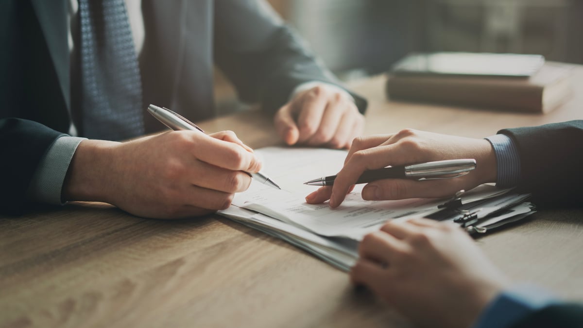 Real estate contract being signed — lease trap and guarantor review for off-campus Austin housing