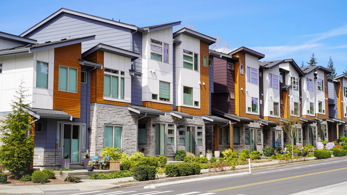 A row of modern townhomes with contemporary architecture and mixed-material facades