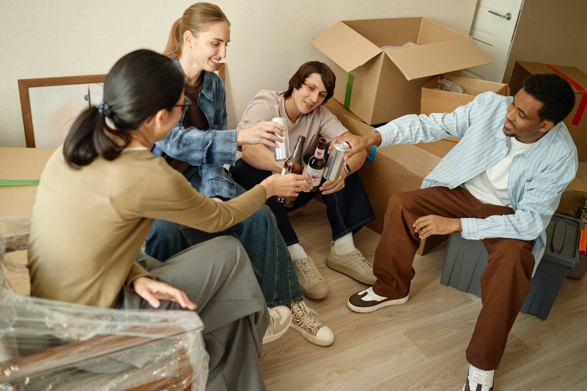 College students collaborating and studying together in a modern apartment living room near campus