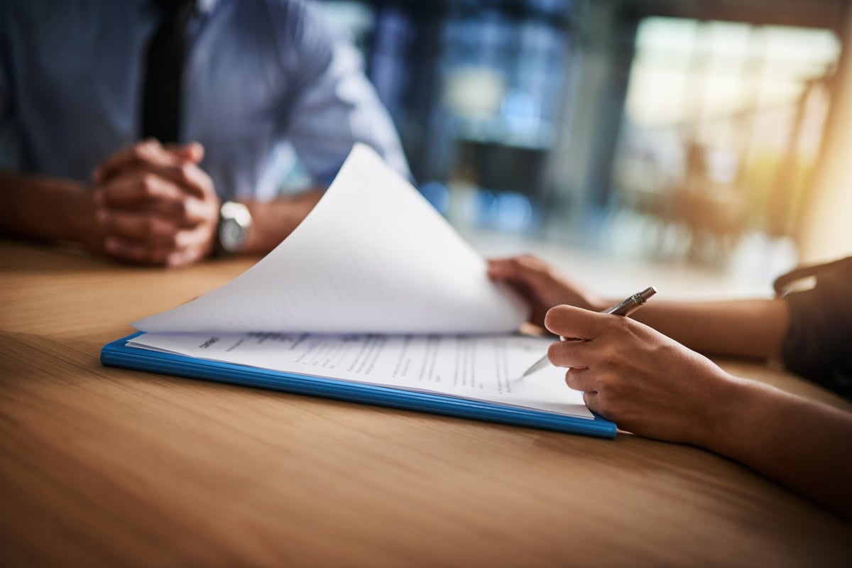 Investor reviewing financing documents and rental property analysis for a Bryan, TX student housing property near Blinn College–Bryan