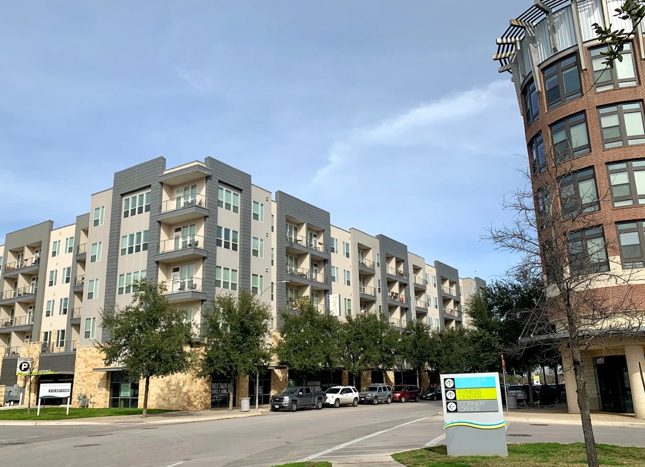 Multistory apartment buildings along a street in East Riverside, Austin.
