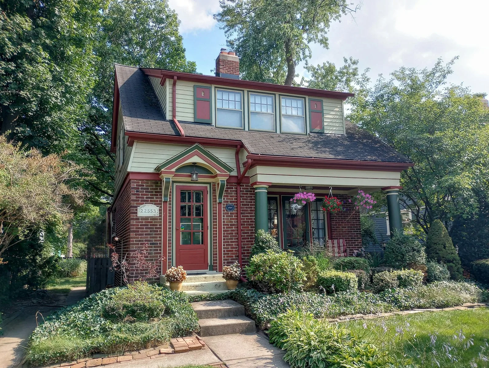 A red-brick home with a red entrance door. Illustrative photography, not a local listing.