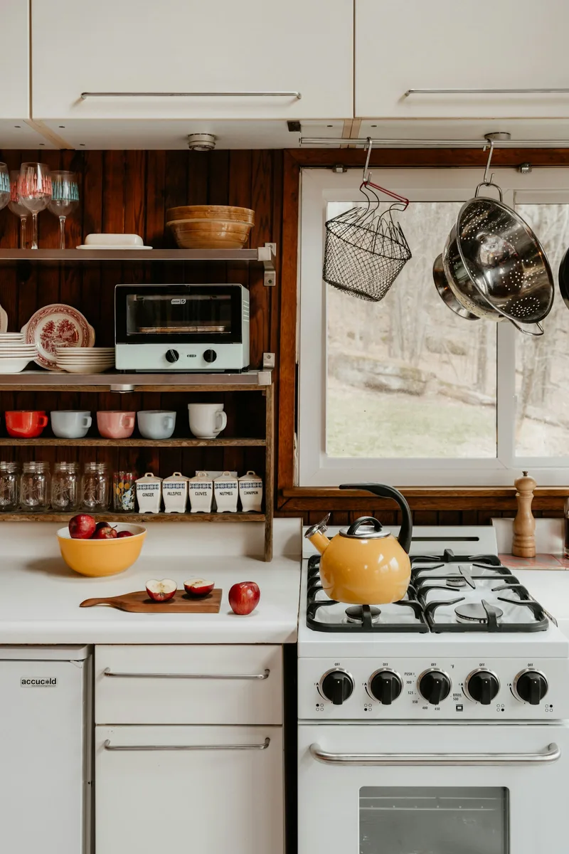 Cooking utensils and a kettle in a farmhouse kitchen. Illustrative photography, not a local listing.