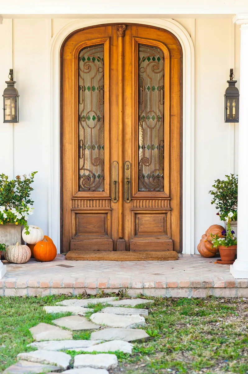 A wooden front door with sidelights at a Dallas home. Illustrative photography, not a local listing.