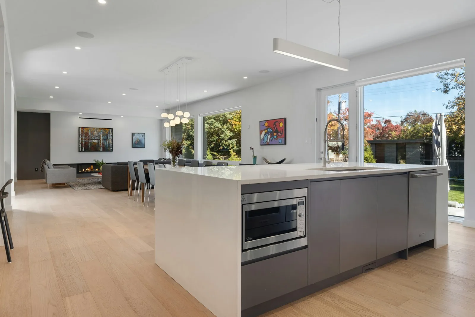 A bright kitchen with a central island and open living area. Illustrative photography, not a local listing.