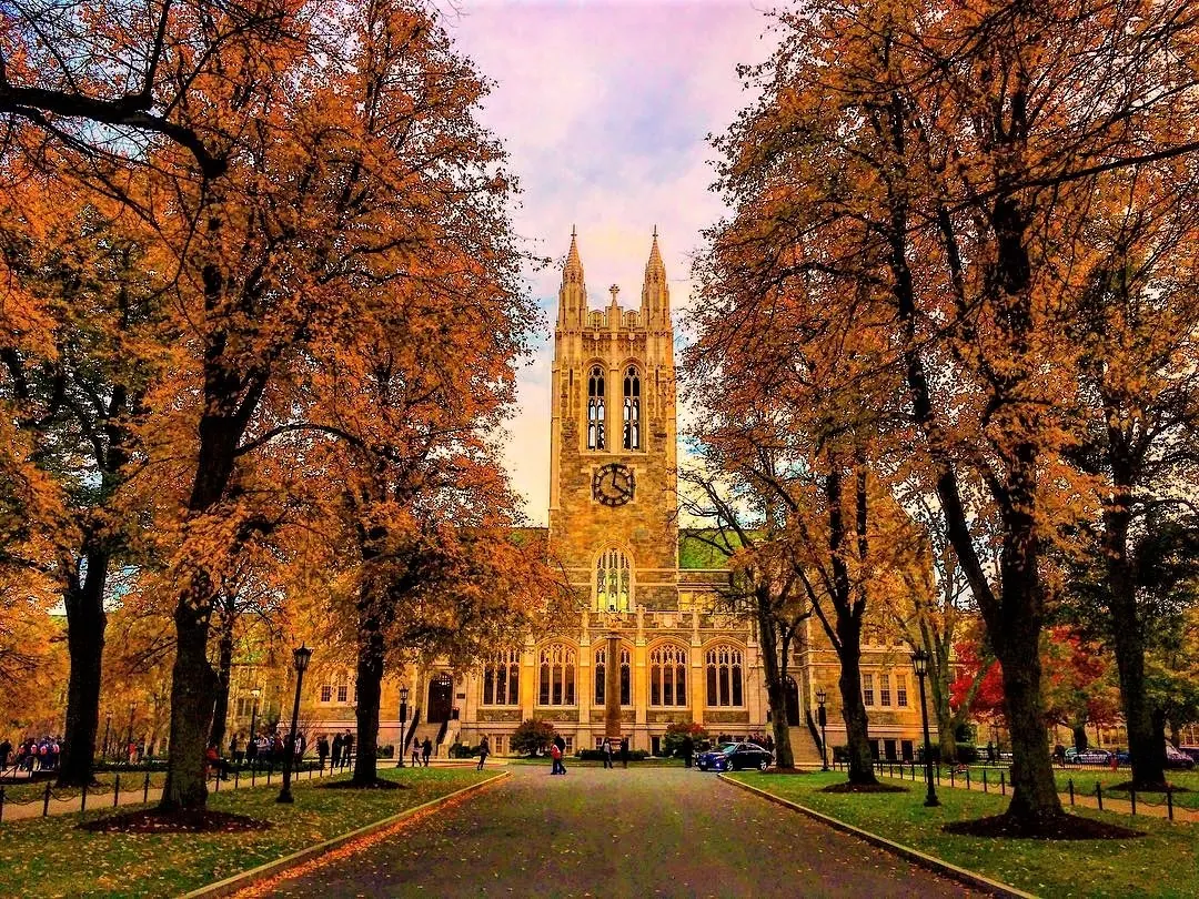 Gasson Hall at Boston College framed by autumn trees and the campus walk.