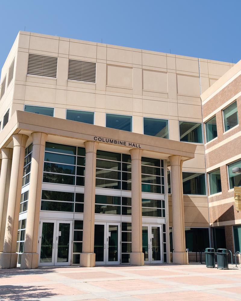 Columbine Hall main entrance at University of Colorado Colorado Springs — recognizable academic building with modern glass facade and campus setting. Photo: Flyfreezer761 / CC0. Independent campus housing information for UCCS.