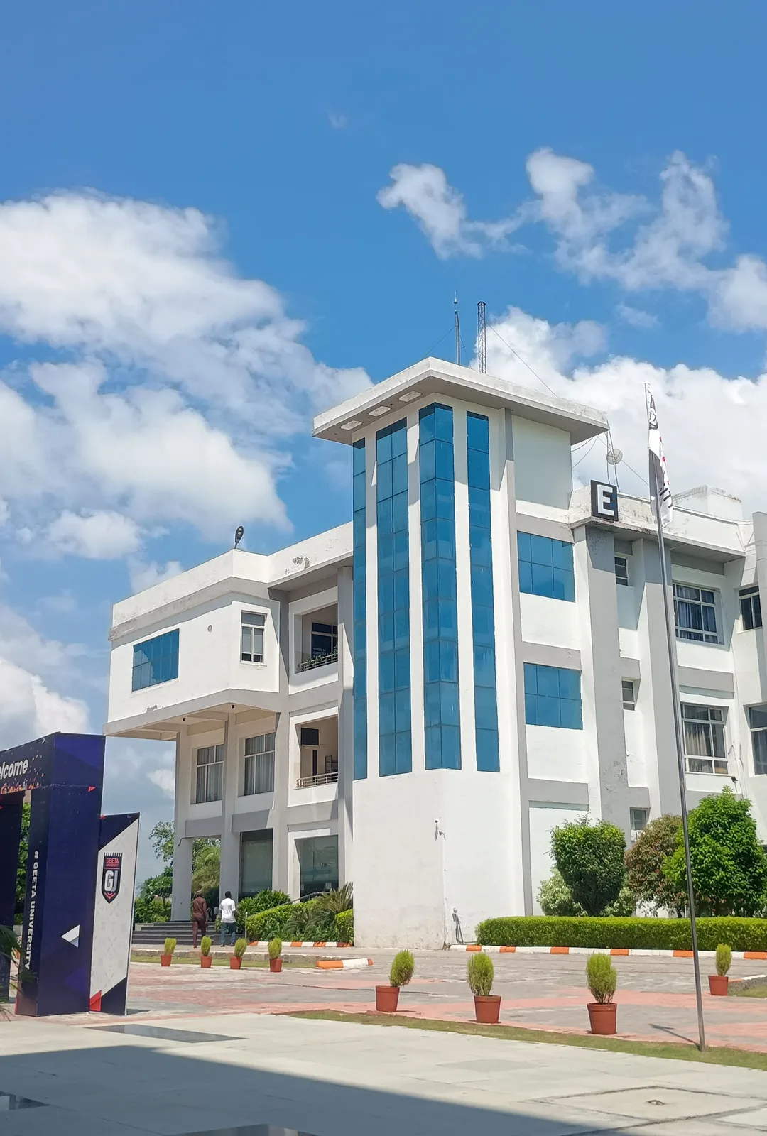 College campus academic building under a blue sky — independent campus housing information for University of Georgia in Athens.