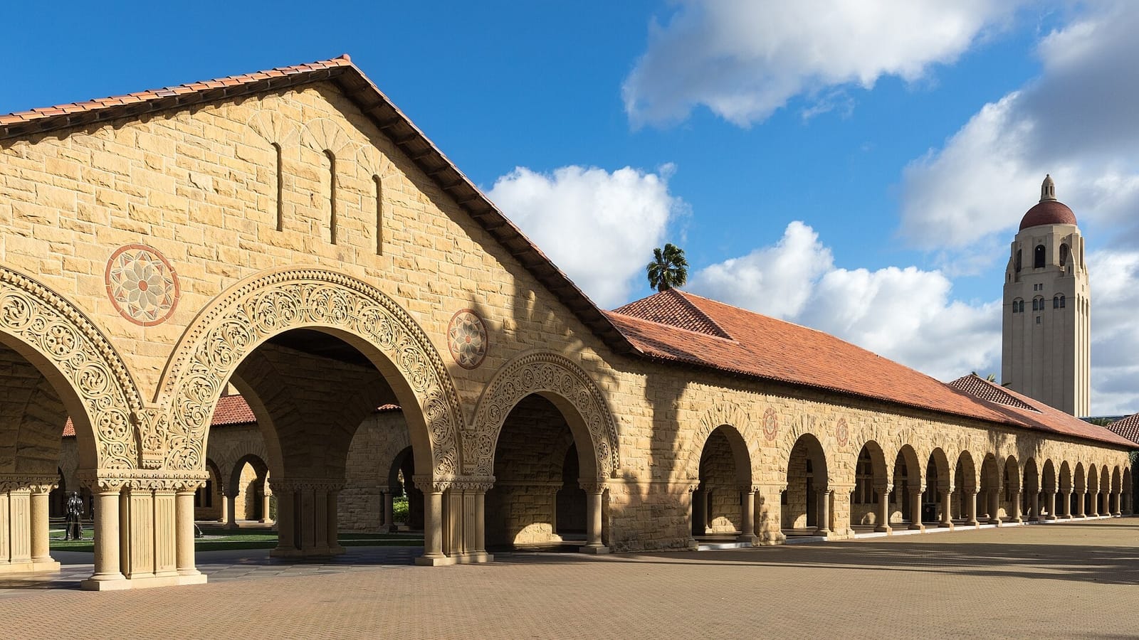 Stanford University’s sandstone Main Quad arches with Hoover Tower in the background.